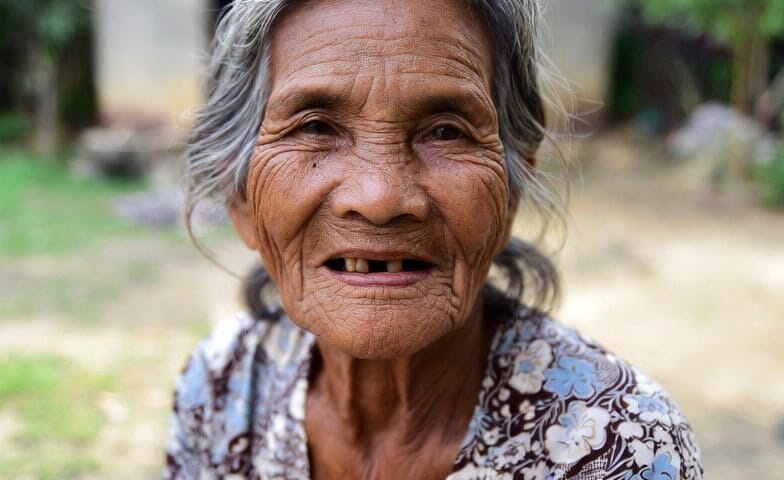 an old poor grandma with a faint smile